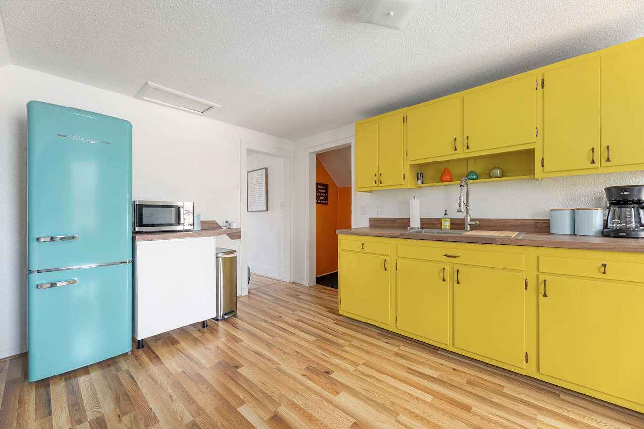 colorful-kitchen-design-teal-fridge-yellow-cabinets
