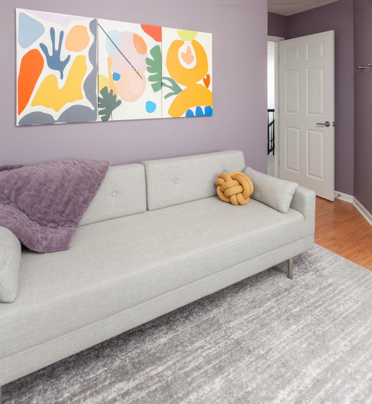 home-office-sofa-wall-art-purple-walls-blanket