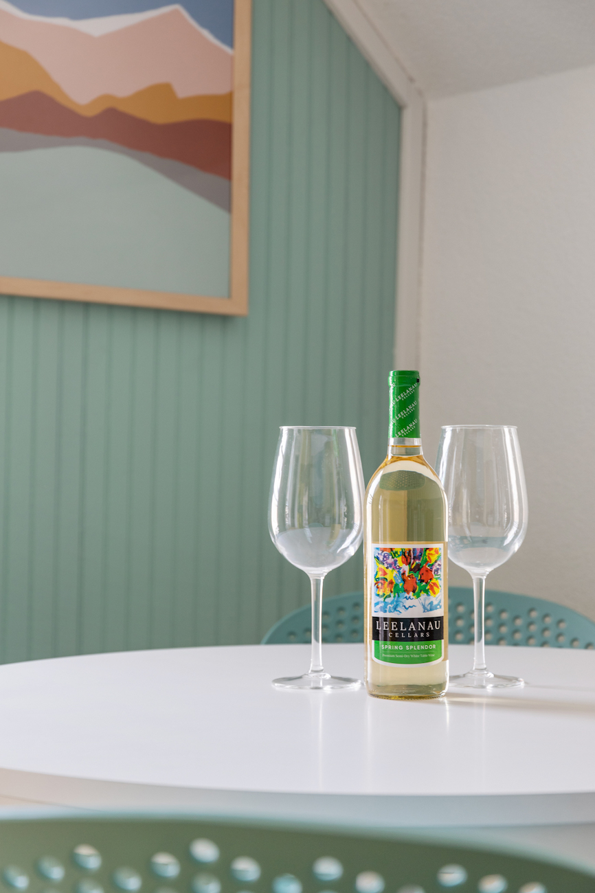 wine-glasses-wine-bottle-teal-accent-wall-dining-table